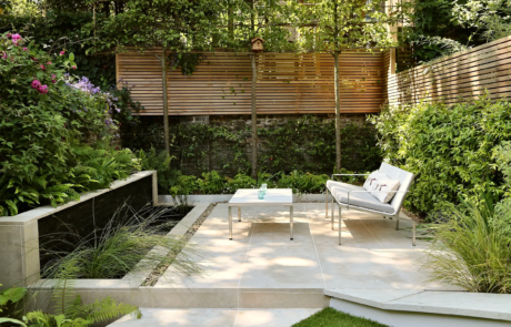 A shady London garden was with limestone paving and splashes of colour