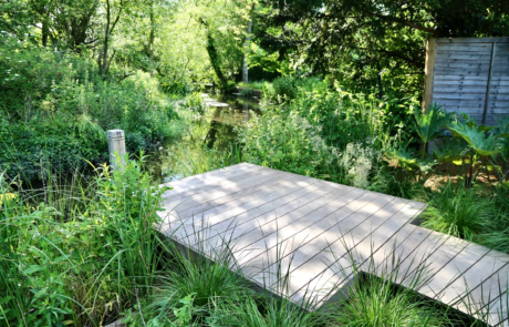 A Hertfordshire garden by a river's edge in the sunshine