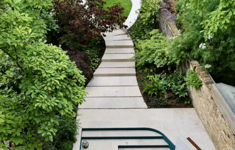 A shady London garden was with limestone paving and splashes of colour