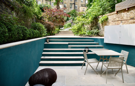 A shady London garden was with limestone paving and splashes of colour