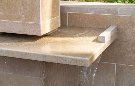 Water running off a stylish modern water feature with angular shapes