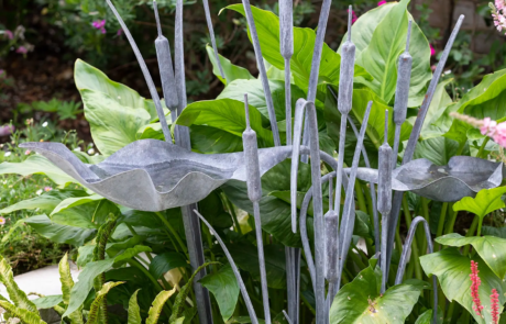 A metal sculpture of tall water plants